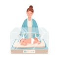 Premature newborn infant lies inside neonatal intensive care unit, female doctor or pediatric nurse stands beside it and