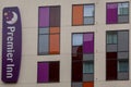 A Premier inn hotel sign and colourful windows on the side of a premier in hotel Royalty Free Stock Photo