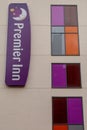 A Premier inn hotel sign and colourful windows on the side of a premier in hotel Royalty Free Stock Photo