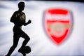 LONDON, ENGLAND, JULY. 1. 2019: Arsenal Football club logo, Premier League, England. Soccer player silhouette Royalty Free Stock Photo