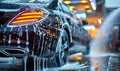 Premium black sedan car undergoing a deep clean with high-foam soap at a car wash station, showcasing a meticulous auto detailing Royalty Free Stock Photo