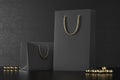 Premium black shopping bags mock-up, package for purchases on a black background. Black paper shopping bag with golden