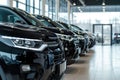 Premium black SUVs in modern dealership showroom with huge windows