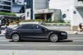 Premium car Audi A8 2014 model fast drive on road in the city with blurred background