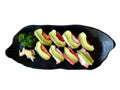 The premium Japanese avocado salmon roll on a black plate