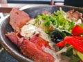 Premium Japanese beef Wagyu thin grilled and sliced topping with white Italian dressing sauce and salad in a bowl Royalty Free Stock Photo