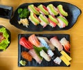 The premium Japanese sushi set place on black plate with wasabi