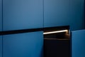 Premium kitchen interior. Drawer lighting. Stylish blue design Royalty Free Stock Photo
