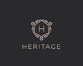 Premium linear shield monogram letter H logotype. Elegant crest leaf stamp icon vector logo. Luxury alphabet frame