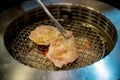 Premium pork slice grilled on yakiniku stove which has hot charcoal. Barbecue Japanese style. Royalty Free Stock Photo