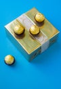 Wrapped chocolates placed on the golden gift box. Royalty Free Stock Photo