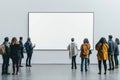 Diverse group of people looking at a large blank canvas in an art gallery Royalty Free Stock Photo