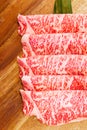 Premium Rare Slices Wagyu A5 beef with high-marbled texture on square wooden plate served for Sukiyaki and Shabu Royalty Free Stock Photo