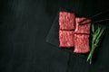 Premium raw Black Angus beef minute steak on Black wooden background. Slice wagyu