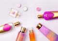 Premium skin care cosmetics and perfume on purple background.