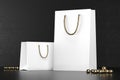 Premium white shopping bags mock-up, package for purchases on a black background. White paper shopping bag with golden Royalty Free Stock Photo