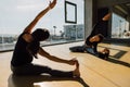 Pregnant woman doing yoga with personal teacher