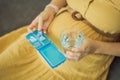 Prenatal Vitamins. Portrait Of Beautiful Smiling Pregnant Woman Holding Pill Box and a glass of water, Taking Royalty Free Stock Photo