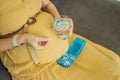 Prenatal Vitamins. Portrait Of Beautiful Smiling Pregnant Woman Holding Pill Box and a glass of water, Taking Royalty Free Stock Photo