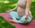 Prenatal yoga. Caucasian pregnant woman doing butterfly pose in the park. Royalty Free Stock Photo