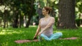 Prenatal yoga. Caucasian pregnant woman doing butterfly pose in the park. Royalty Free Stock Photo