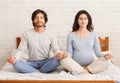 Pregnant woman doing yoga breathing exercises together with her husband Royalty Free Stock Photo