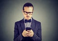 Preoccupied sad man thinking what to reply to received text message on cell phone Royalty Free Stock Photo