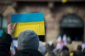 Preople protesting with ukrainian flag against the war