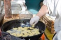 Preparacion deep fried fritters donuts in market