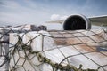 Loading of cargo containers against jet engine of plane Royalty Free Stock Photo