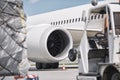 Loading of cargo containers against jet engine of plane Royalty Free Stock Photo