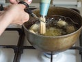 Preparation of Arabic dessert Tulumba in boiling oil. Tulumba- arabian syrup-soaked fried sponge honey