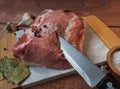 Preparation for baking pork loin with bay leaf and garlic, a large piece lies