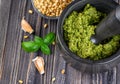 Preparation of basil pesto sauce with the main ingredients: fresh basil leaves, parmesan cheese, pine nuts, garlic Royalty Free Stock Photo