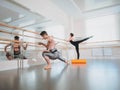 Preparation of body before performance in ballet studio. Male dancer and ballerina warming up near barre on rehearsal Royalty Free Stock Photo