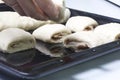 Preparation of cinnamon rolls. A woman puts buns of buns on a baking tray. Royalty Free Stock Photo