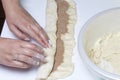 Preparation of cinnamon rolls. The woman turns off the dough with a filling of cinnamon and sugar. Royalty Free Stock Photo