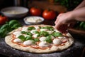 Preparation of classic Italian pizza with homemade tomato sauce, basil and mozzarella