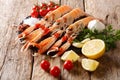 Preparation for cooking raw langoustine, scampi with vegetables, herbs and spices close-up on a board on a wooden. horizontal Royalty Free Stock Photo