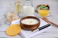 Preparation of cosmetic masks at home. Oatmeal, milk, honey, herbs on a light background. Concept of beauty treatments and spa Royalty Free Stock Photo