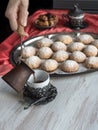 Preparation of delicious aromatic Turkish coffee with Cezve Ibrik. Sweets and black coffee on a wooden table Royalty Free Stock Photo