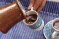 Preparation of delicious aromatic Turkish coffee with Cezve/ Ibrik,traditional turkey beverage. Royalty Free Stock Photo