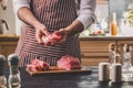 Preparation of dinner. Cooking, processing of meat beef, tenderloin . Person man`s hands marinates meat - sprinkles with