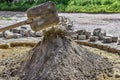 Preparation of a dry cement-sand mixture for the repair of stone paving slabs, garden paths, courtyards or city squares. Mixing