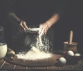 Man preparing bread dough on wooden table in a bakery close up. Preparation of Easter bread. Royalty Free Stock Photo