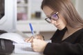 Preparation for exams. Young teenage girl at home studies, writes, reads, remembers Royalty Free Stock Photo