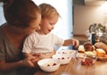 preparation of family breakfast. mother and baby son cook porridge in morning Royalty Free Stock Photo