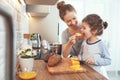 Preparation of family breakfast. mother and child daughter cut b