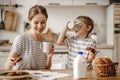 Preparation of family breakfast. mother and child son cut bread and eat cookies with milk in morning