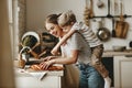 Preparation of family breakfast. mother and child son cut bread in morning